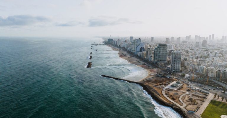 Stunning aerial view of Tel Aviv skyline and beach, showcasing vibrant city and coastline.