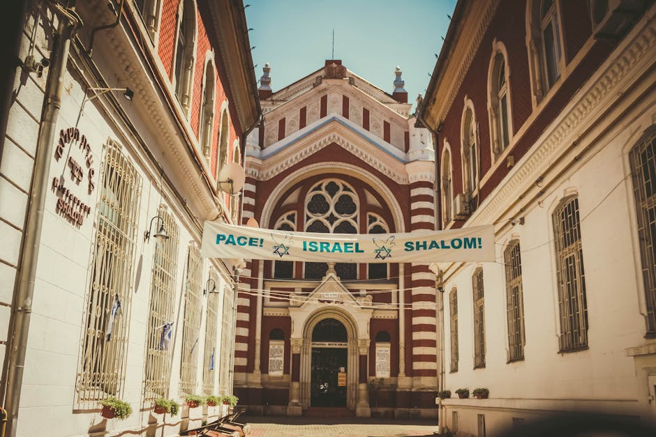 Gothic Revival architecture of Brașov Synagogue with a peace message banner under daylight.