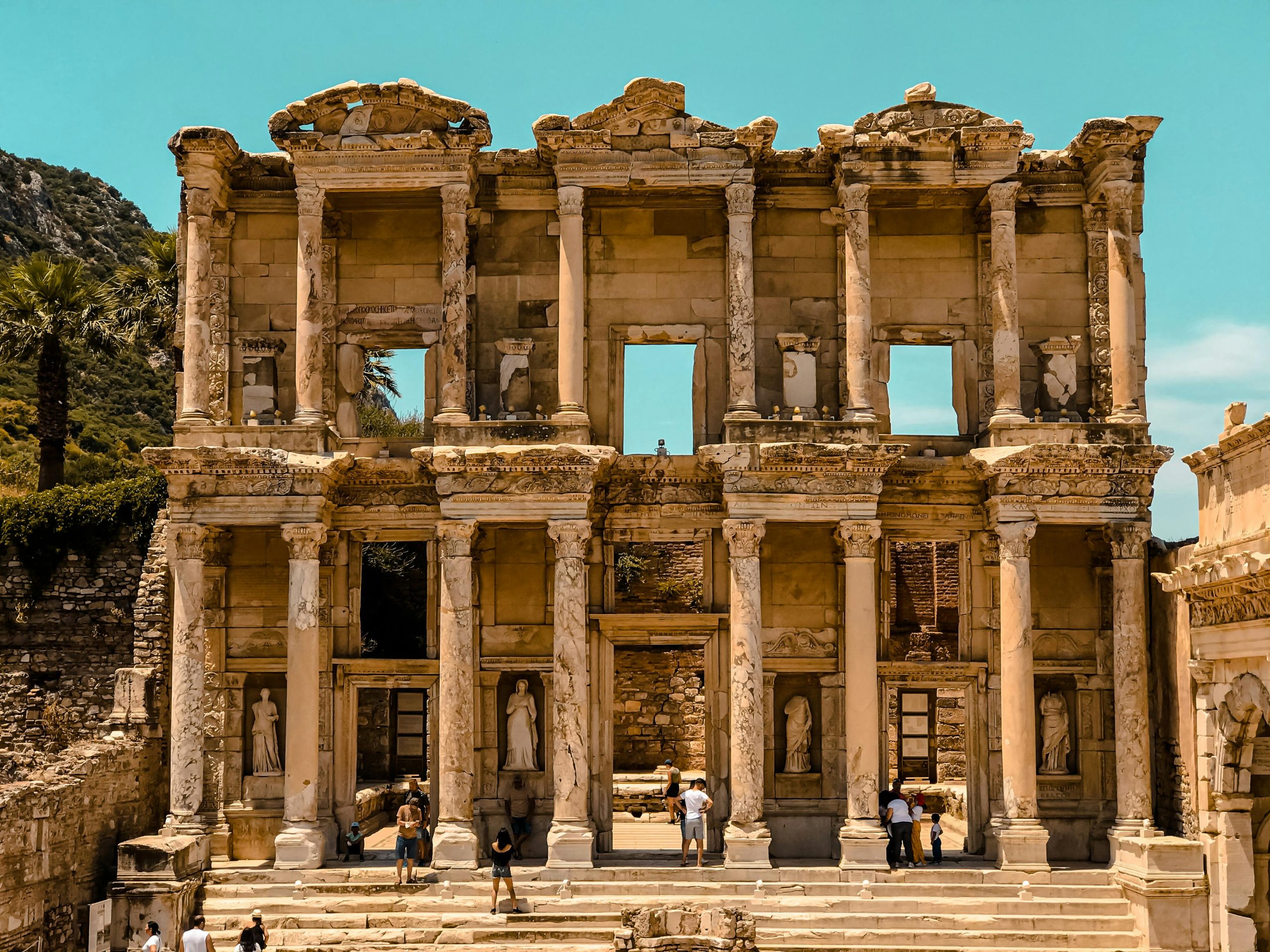 The ancient ruins of the Library of Celsus in Ephesus with detailed stone carvings and statues.